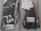 two pairs of gloves that are wrapped in plastic