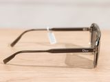 christian dior sunglasses on a wooden table with a tag on it