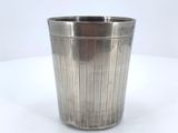 a metal cup that is sitting on a table