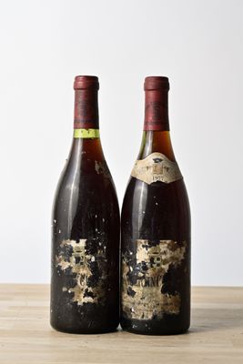 two bottles of wine sitting on top of a wooden table next to each other
