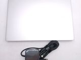 a laptop and a charger sitting on a table