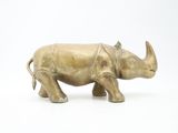 a bronze statue of a rhinocero on a white background