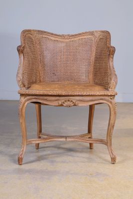 Fauteuil de bureau en bois mouluré et canné.