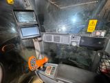 an image of a car dashboard with a monitor and a laptop