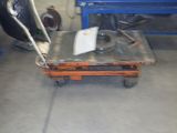 a dolly with a piece of metal on it in a garage