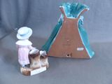 a small figurine of a woman with a hat next to a tent