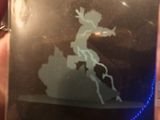 a picture of a person holding a card with a picture of a person on a horse