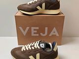 a pair of veja shoes in brown and white with a box