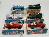 several toy cars are lined up in a row on top of boxes