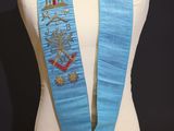a close up of a mannequin wearing a blue sash with a star on it