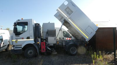 a white dump truck that is parked in a lot