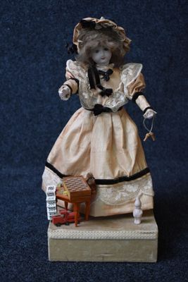a figurine of a woman in a dress and hat