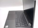 a laptop that is open on a white surface