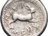 a close up of a silver coin with a deer on it