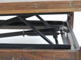 underside view of a wooden table with a pair of screws on it