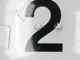 a black and white number two on the side of a white car