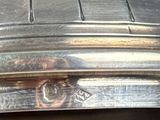 a close up of a silver plate with a clock on it