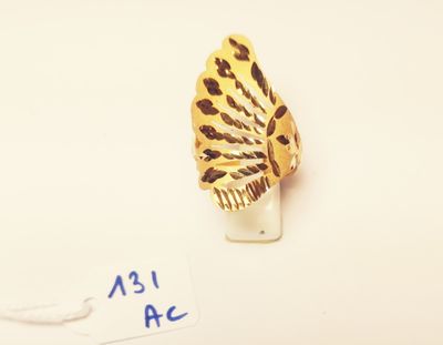 a gold ring with a black and white butterfly on it