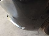 a close up of a car ' s front bumper with a hole in it