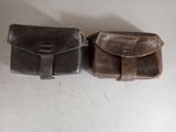 two brown leather cases sitting on a white surface