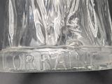 a clear glass bottle with a black label on it