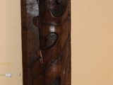 a wooden carving of a man and a woman