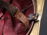 a close up of a helmet with a leather strap