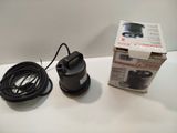 a box with a cord attached to it next to a water pump