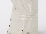 a white ceramic statue of a woman with a veil on her head