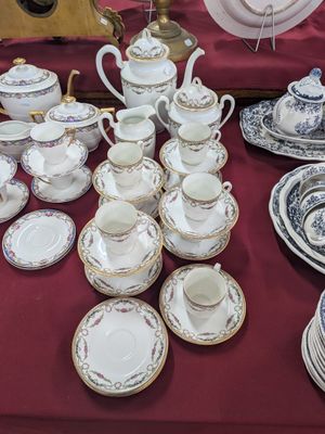 plusieurs assiettes et tasses sur une table avec une nappe rouge