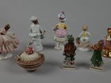 five figurines of different sizes and colors on the table