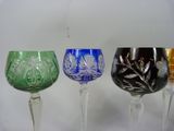 three wine glasses sitting next to each other on a table