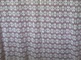 a curtain with a pattern on it hanging on a wall