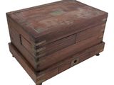 an old wooden box with two drawers on top of it