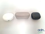 a close up of a pair of ear buds sitting on top of a table