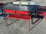 tables and chairs in a parking lot with a truck in the background
