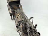 a statue of a horse pulling a carriage on a white surface