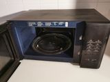 a microwave with a speaker inside of it sitting on a counter