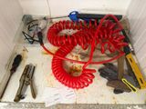 a red coiled hose sitting on top of a sink