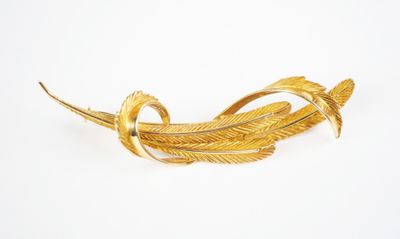 an image of a gold plated brooch with leaves on it