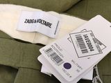 two tags on the back of a green jacket