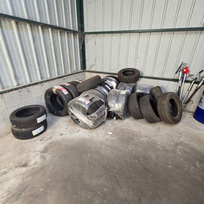 a pile of tires and other items in a garage
