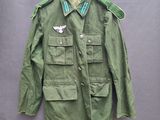 une veste vert militaire avec un oiseau blanc sur la poitrine et un col vert