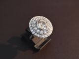 a diamond ring sitting on top of a wooden stand