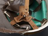 a brown and green baseball glove in a white bowl