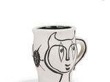 a coffee cup with a drawing of a cat on it
