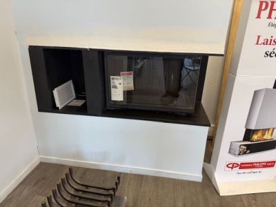 a picture of a fireplace in a room with a lot of chairs