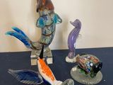 two figurines of fish and a turtle on a table