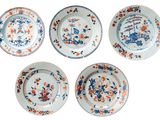 four plates with floral designs on them on a white surface