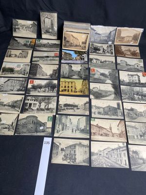 a lot of old postcards on a black table